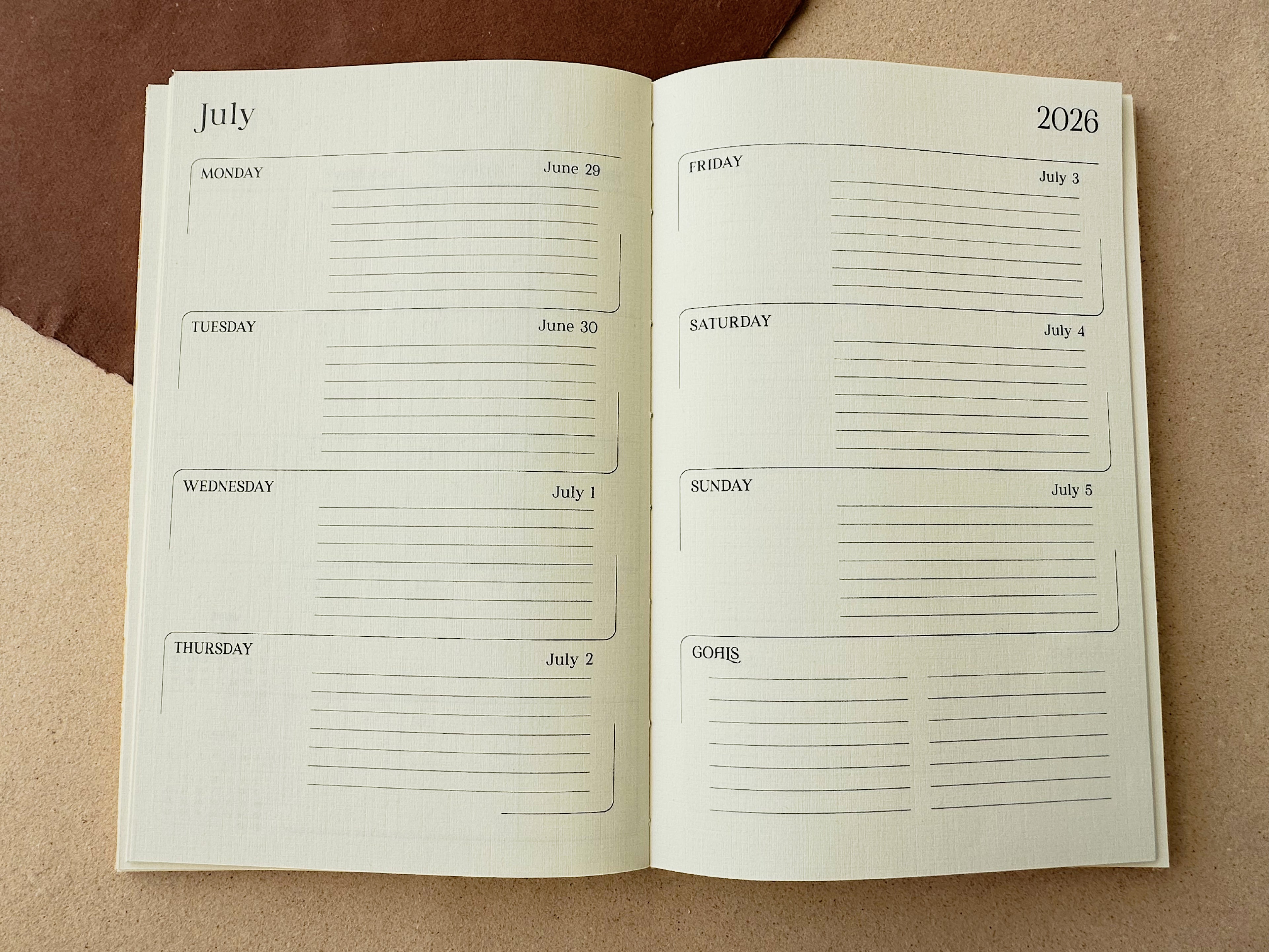 Open planner showing a July 2023 layout on a brown background