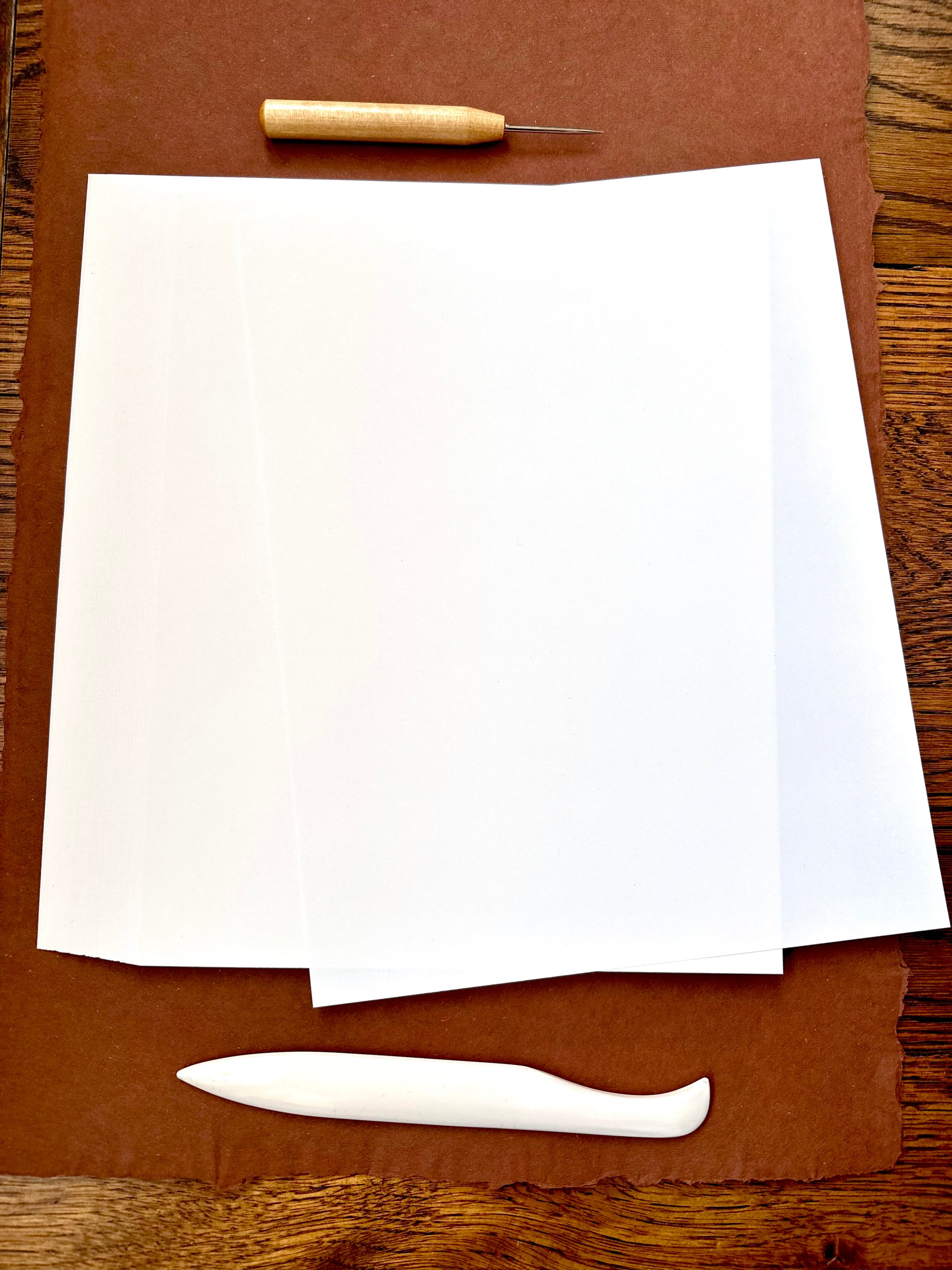 BLANK Short Grain Bookbinding Paper - 8.5" x 11"-  to enhance your book binding projects.  This smooth finish, 70 lb. text weight white paper is 20% post consumer waste and acid free, ensuring high quality and eco-friendly book binding projects.